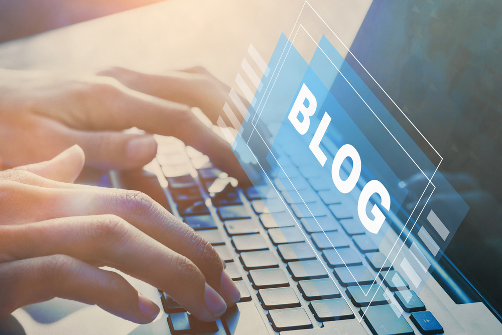 How to Optimize Your Blog Posts for SEO - Hands typing on a laptop keyboard with a 3d pop out that says 'blog'